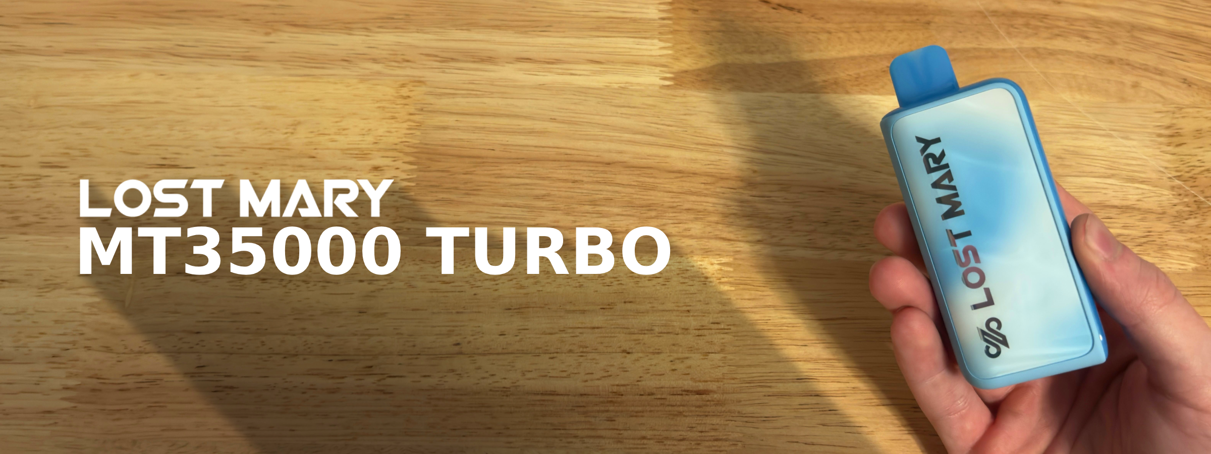 Lost Mary MT35000 Turbo disposable vape shown in hand with sleek blue design on wooden background.